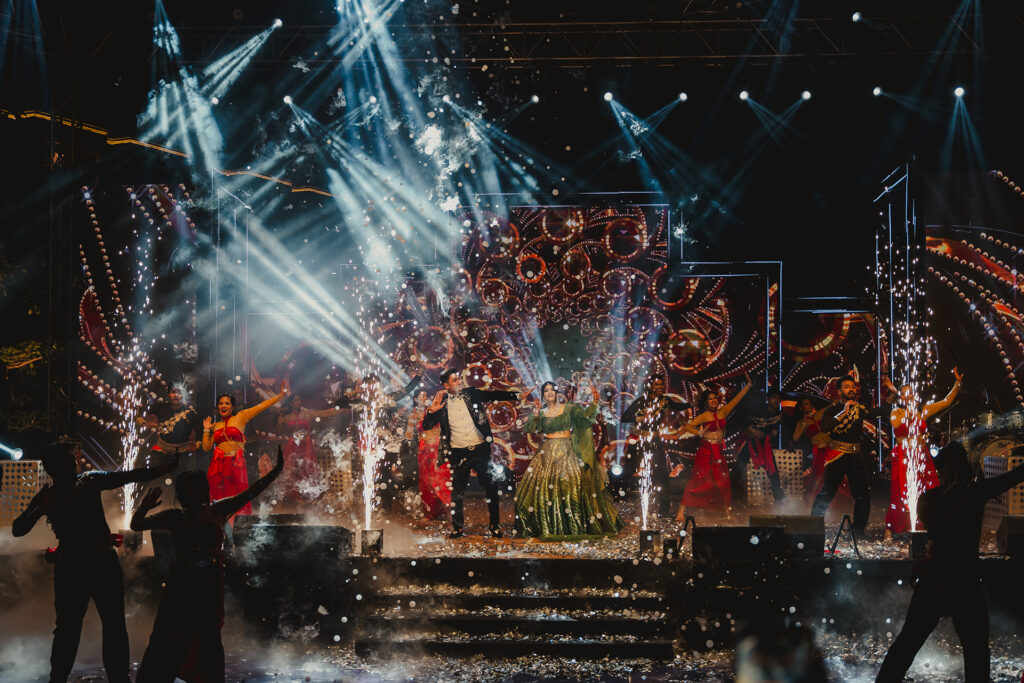 Sangeet stage performance with lights and sparklers at Shubham and Sumegha's wedding