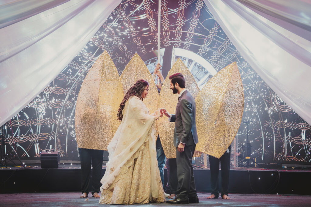 Couple dancing in front of a white feather-wing stage set