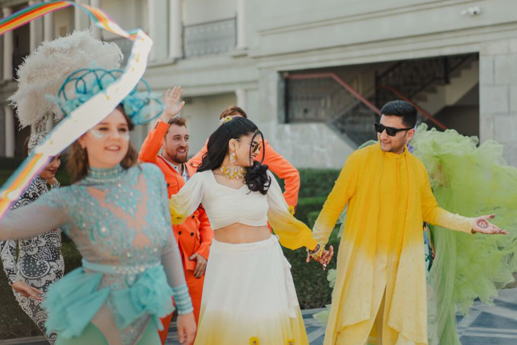 Costumed dancers performing with guests at a mehendi celebration